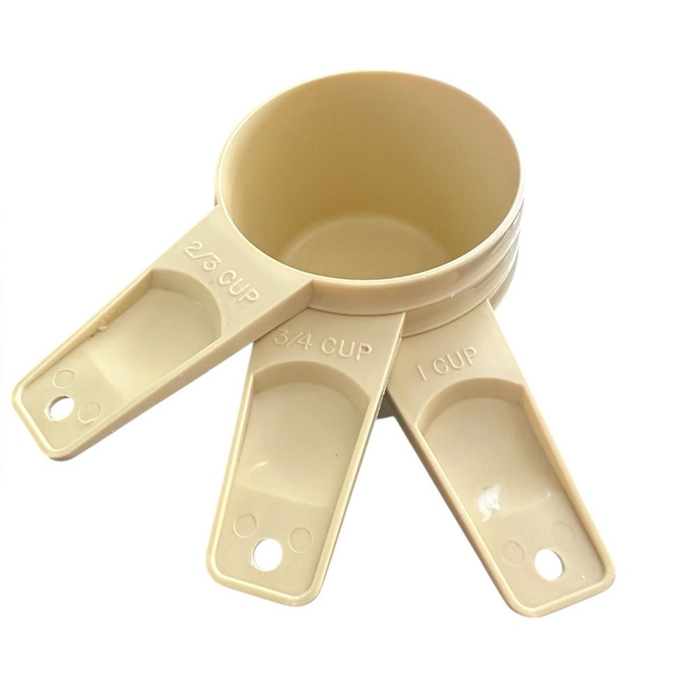 Tupperware set of vintage yellow colored plastic Tupperware‎ measuring cups